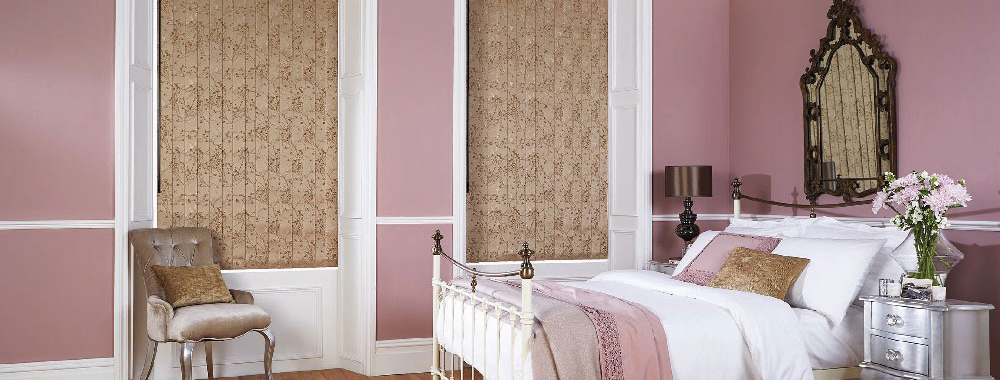 Patterned vertical blinds in a pink bedroom