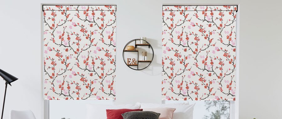 Floral pattern roller blinds above a white sofa